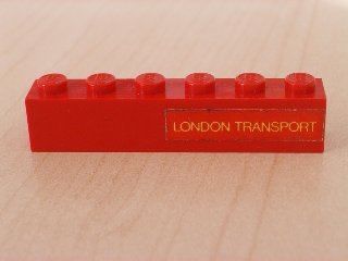 3009pb067 | Brick 1 x 6 with Yellow 'LONDON TRANSPORT' Text on Red Background Pattern Model Right Side | LEGOPART